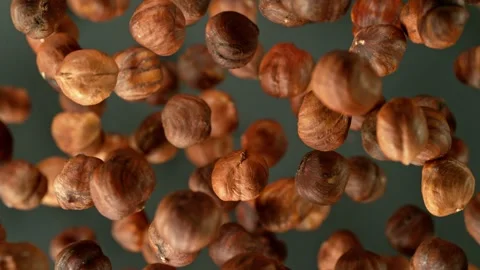 Super slow motion of rotating hazelnuts up to the air. Stock Footage 243022030