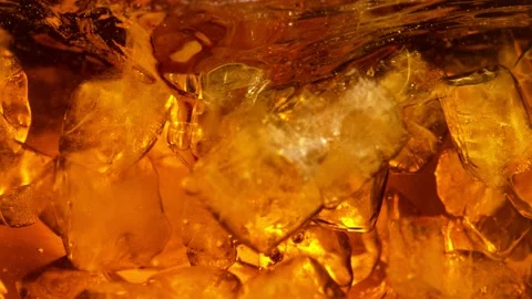 Super slow motion of rotating ice cubes in cola or alcoholic drink Vídeo Stock 148156146