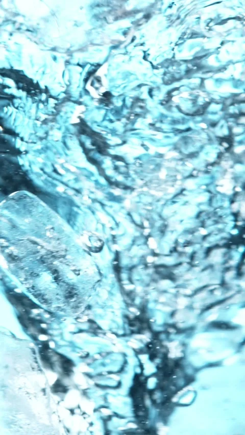 Super slow motion of rotating ice cubes in water. Stock Footage 308705833