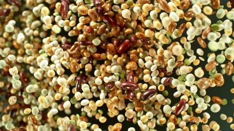 Super slow motion of rotating mix legumes pieces in the air. Stock Footage 239302530