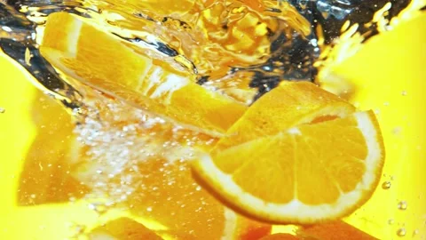 Super slow motion of rotating orange slices underwater. Stock Footage 193182052