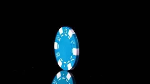Super slow motion of rotating poker chips on black table. Stock Footage 130641189