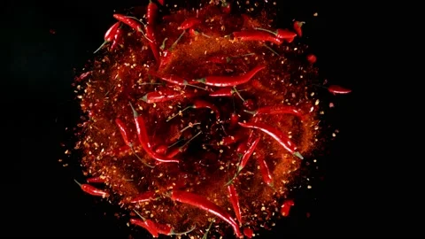 Super slow motion of rotating red chilli peppers isolated on black Stock Footage 166703161