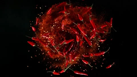 Super slow motion of rotating red chilli peppers isolated on black Stock Footage 189420541