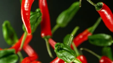 Super slow motion of rotating red chilli peppers isolated on black Stock Footage 238439676
