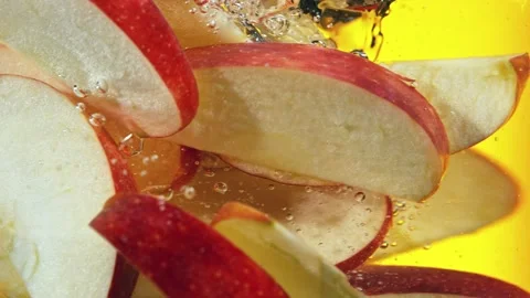 Super slow motion of rotating sliced red apples pieces underwater Stock Footage 193317868