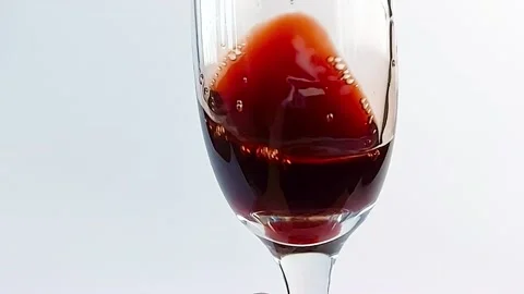 Super slow motion rotation of red wine in a glass. Stock Footage 168472479
