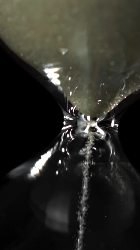 Super slow motion sand fall in the hourglass. Filmed on a high-speed camera at Stock Footage 335367616
