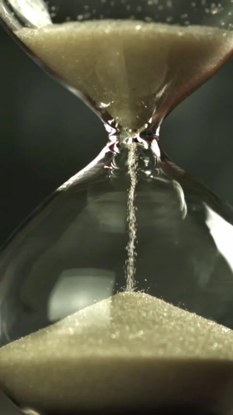 Super slow motion sand fall in the hourglass. Filmed on a high-speed camera at Stock Footage 335376649
