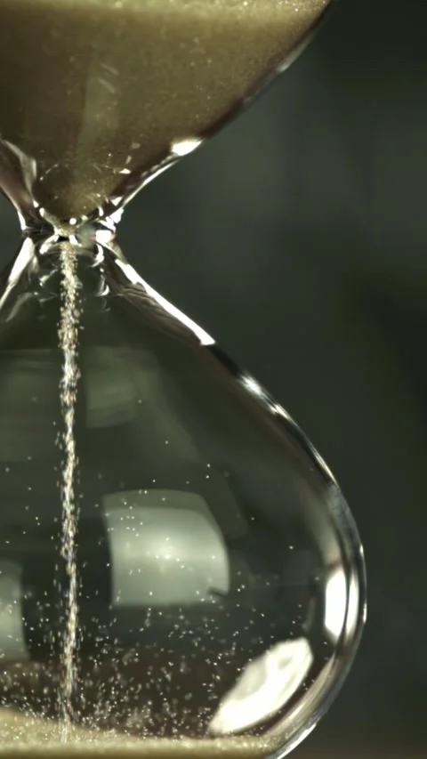 Super slow motion sand fall in the hourglass. Filmed on a high-speed camera at Stock Footage 335383111