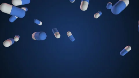 Super slow-motion shooting of blue - and-white pills falling into the bottom. Lo Stock Footage 156430365