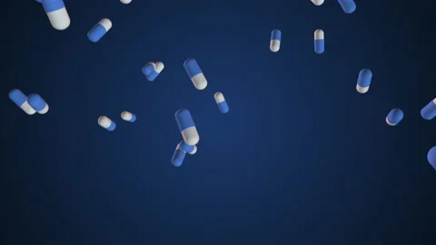 Super slow-motion shooting of blue - and-white pills falling into the bottom. Lo Stock Footage 156431205
