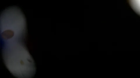 Super slow motion shooting. round multicolored confetti fall on the camera's Stock-Footage 88698983