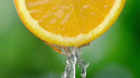 Super slow motion shooting of sliced orange slice with splashes of water, Stock Footage 248787314