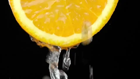 Super slow motion shooting of sliced orange slice with splashes of water, Stock Footage 248788204