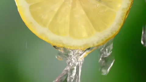 Super slow motion shooting of sliced lemon slices with splashes of water, Stock Footage 248788739