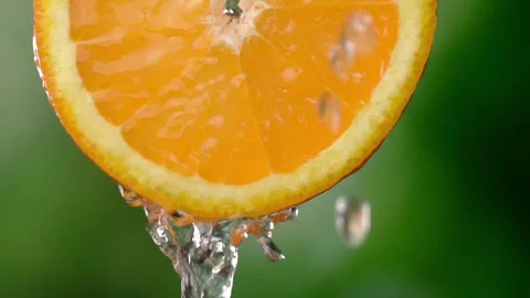 Super slow motion shooting of sliced orange slice with splashes of water, Stock Footage 248895901