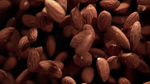 Super Slow Motion Shot of Almonds Flies After Being Exploded against Black Stock Footage 119761718