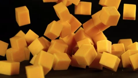 Super Slow Motion Shot of Cheese Cubes Falling on Black Background at 1000 fps. Video stock 140649919