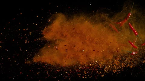 Super Slow Motion Shot of Chilli Peppers and Powder Isolated on Black Background Stock Footage 340465627