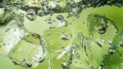 Super Slow Motion Shot of Clear Ice Cubes Falling into Water at 1000fps. Stock Footage 340464731