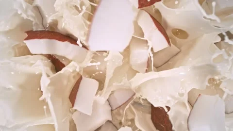 Super Slow Motion Shot of Coconut Cuts Followed by Camera Falling into Milk at Vídeos de archivo 275012609