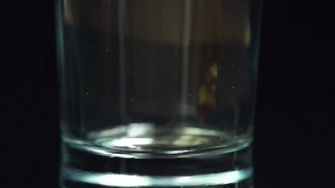 A super slow motion shot of cola being poured into a glass close-up Stock Footage 87857251