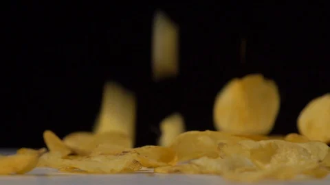 Super slow motion shot of crispy potato chips falling on white table Stock Footage 126144763