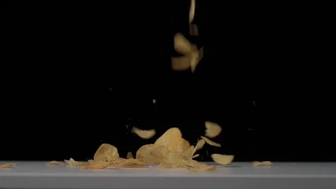 Super slow motion shot of crispy potato chips falling on white table Stock Footage 126145183