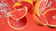 Super Slow Motion Shot Of Cut Grapefruit With Splashing Water Stock Footage