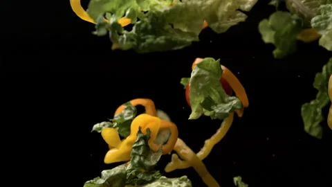 A Super Slow Motion Shot of Diced Vegetables Falling Against Black Background Stock Footage 270409473