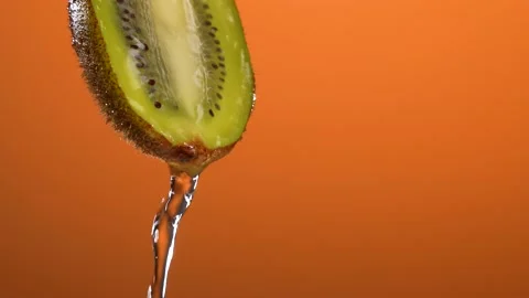 Super Slow Motion Shot of droping water on Kiwi Slices and Splashing Water on Stock Footage 201341875