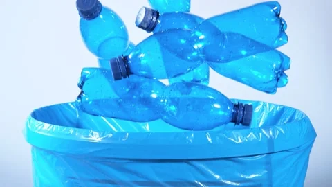 Super Slow Motion Shot of Empty Plastic Bottles Falling Into Trash Can at Stock Footage 151861573
