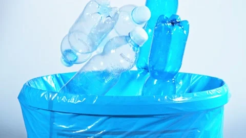 Super Slow Motion Shot of Empty Plastic Bottles Falling Into Trash Can at Stock Footage 153264929
