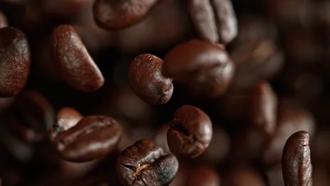 Super Slow Motion Shot of Exploding Premium Coffee Beans Towards the Camera at Stock Footage 113686847