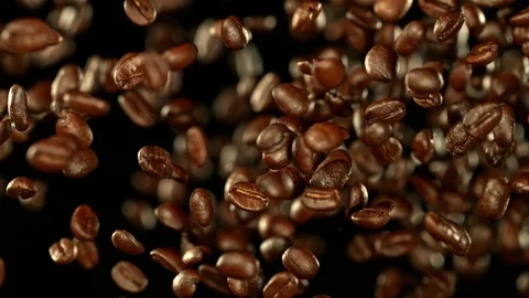 Super Slow Motion Shot of Exploding Premium Coffee Beans Towards the Camera at Stock Footage 114769198