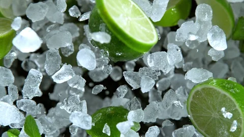 Super Slow Motion Shot of Exploding Crushed Ice, Lime and Mint Towards Camera at Stock Footage 120133285