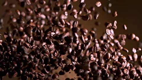 Super Slow Motion Shot of Exploding Premium Coffee Beans on Brown Gradient Stockbeeldmateriaal 164694198