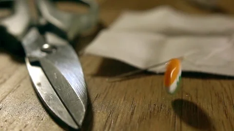 Super slow motion shot of falling and bouncing Irish flag button. Made in Stock Footage 70582350