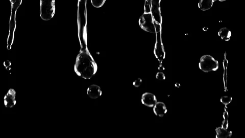 Super Slow Motion Shot of Falling Water Droplets Isolated on Black Background at Stock Footage 129778800