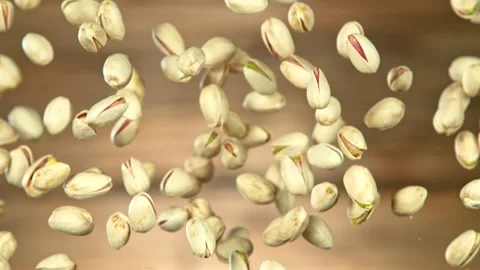 Super Slow Motion Shot of Falling Pistachios After Being Exploded on Wooden 스톡 동영상 137520503
