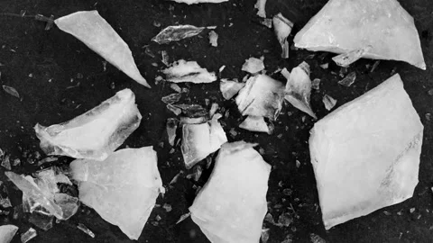 Super Slow Motion Shot of Falling Piece of Ice on Black Stone Background Stock Footage 142212097