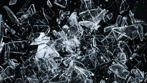 Super Slow Motion Shot of Falling and Shattering Glass Shards Isolated on Black Video stock 228951134