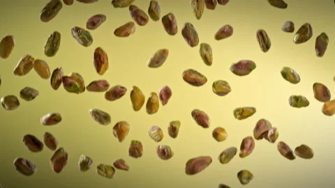 Super Slow Motion Shot of Falling Peeled Pistachio Nuts on Gradient Background Stock Footage 312091982