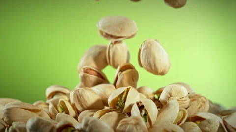 Super Slow Motion Shot of Falling Pistachio Nuts on Gradient Background at Stock Footage 312382163