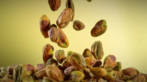 Super Slow Motion Shot of Falling Peeled Pistachio Nuts on Gradient Background Stock Footage 314490796