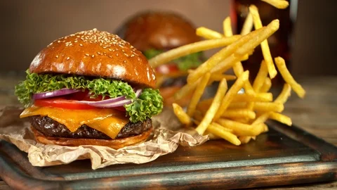Super Slow Motion Shot of Fast Food Concept. Falling French Fries on Wooder Video stock 123690468