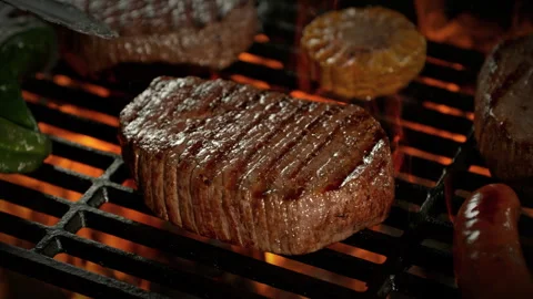 Super Slow Motion Shot of Flipping Beef Steak Meat on Grill with Camera Motion Stock Footage 309084260