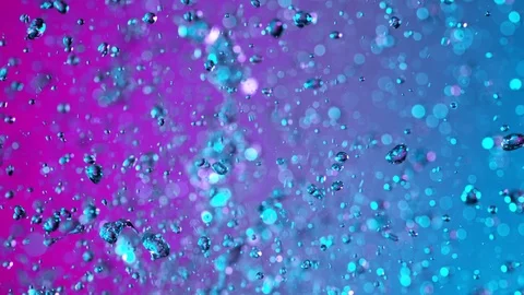 Super Slow Motion Shot Flying Water Drops on Neon Background at 1000fps. Stock Footage 124726581