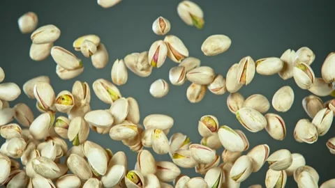 Super Slow Motion Shot of Flying Pistachios After Being Exploded on Grey Video stock 131705005